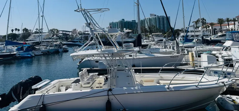 Slide: The Image of 2007 Boston Whaler 320 Outrage docked in a marina with other boats. - 2