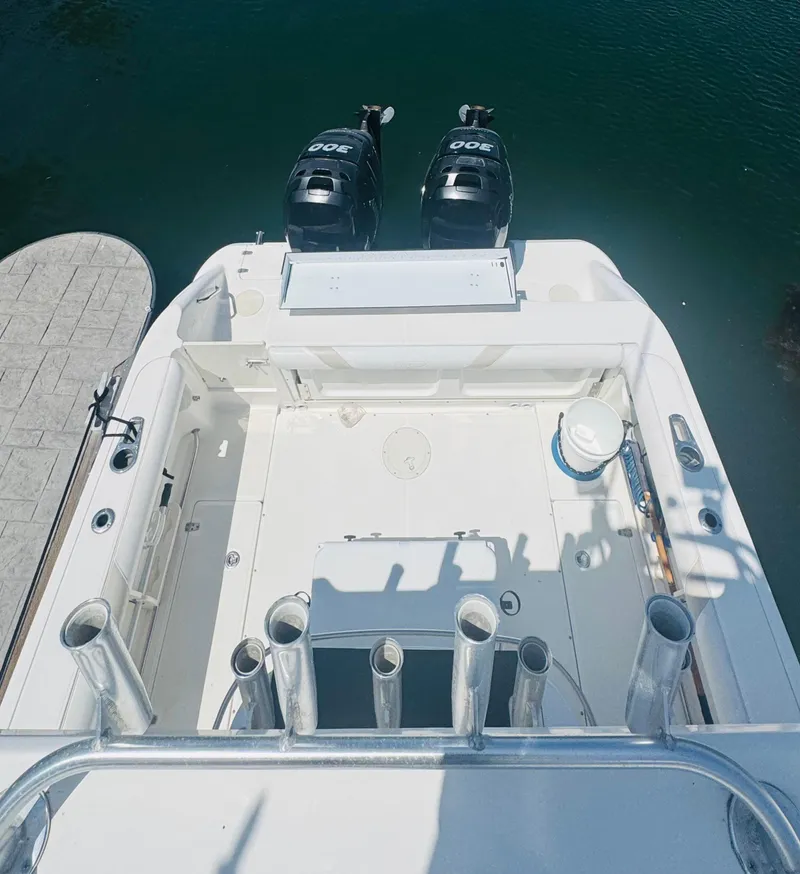 Slide: The Image of 2007 Boston Whaler 320 Outrage boat with dual engines, docked on calm water. - 22