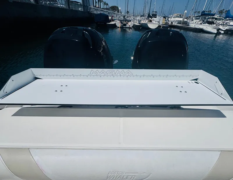 Slide: The Image of 2007 Boston Whaler 320 Outrage boat with dual engines docked in a marina. - 26
