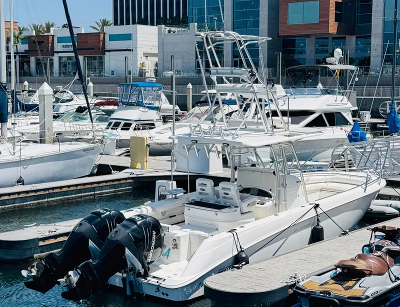 Slide: The Image of 2007 Boston Whaler 320 Outrage docked at a marina with other boats. - 3