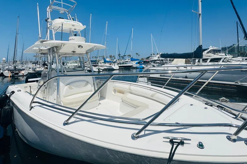 Slide: The Image of 2007 Boston Whaler 320 Outrage boat docked in marina, surrounded by other vessels. - 4
