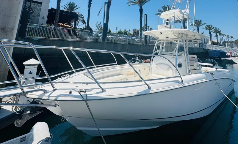 Slide: The Image of 2007 Boston Whaler 320 Outrage boat docked in marina, surrounded by palm trees. - 5
