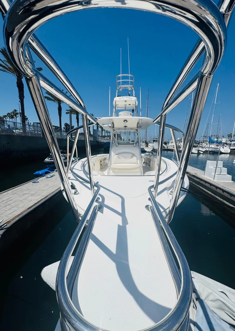 Slide: The Image of 2007 Boston Whaler 320 Outrage boat docked in marina under clear blue sky. - 7