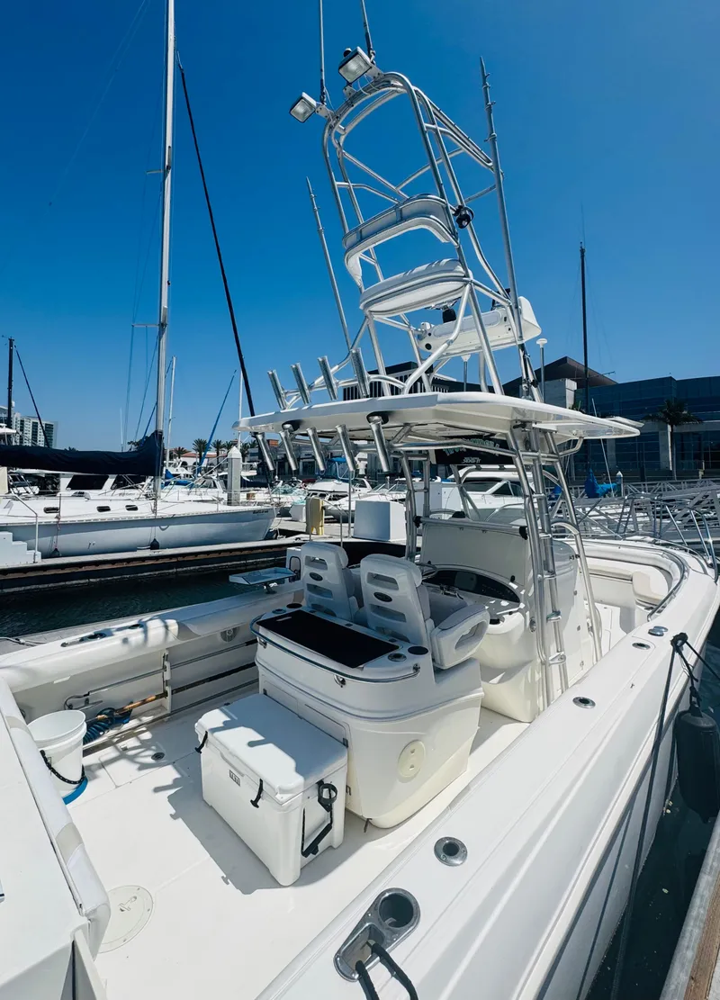 Slide: The Image of 2007 Boston Whaler 320 Outrage boat docked, featuring spacious deck and seating. - 9