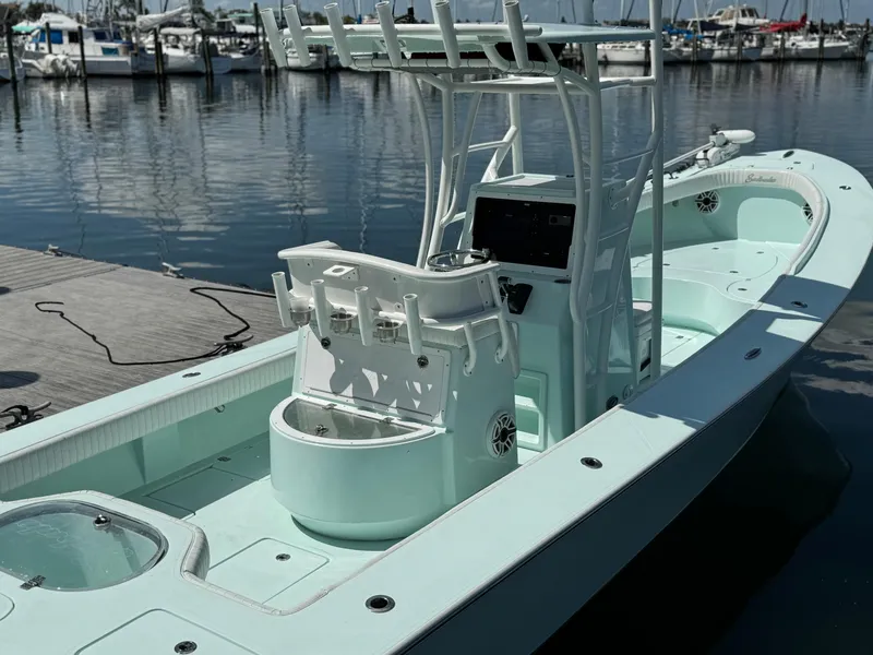 Slide: The Image of 2020 Sabalo 27 boat docked at marina, featuring center console and fishing rod holders. - 10