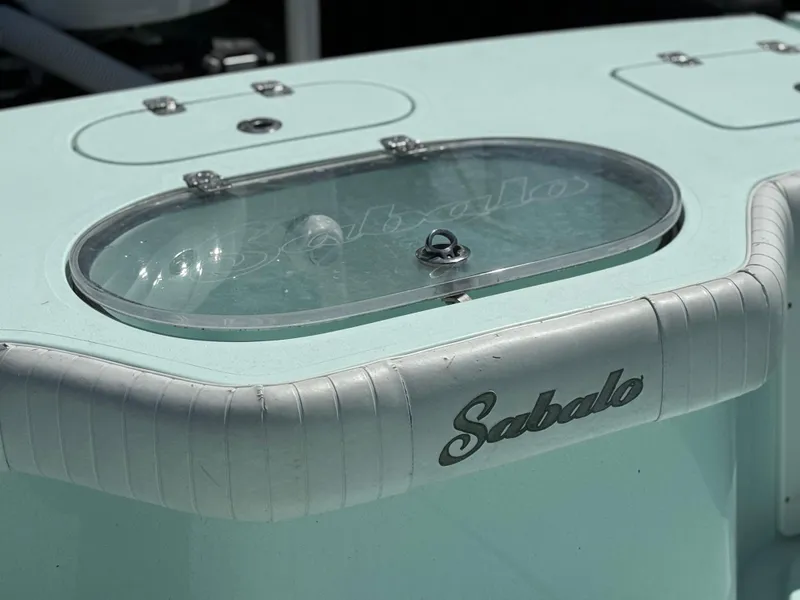 Slide: The Image of Sabalo 27 boat detail, 2020 model, featuring a sleek design and branded livewell. - 13