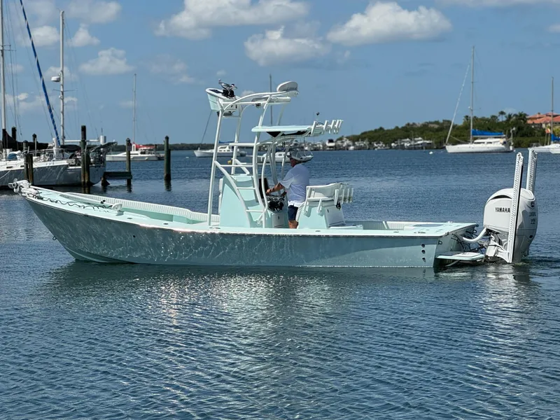 Slide: The Image of 2020 Sabalo 27 boat on calm water with Yamaha engine, clear sky background. - 14