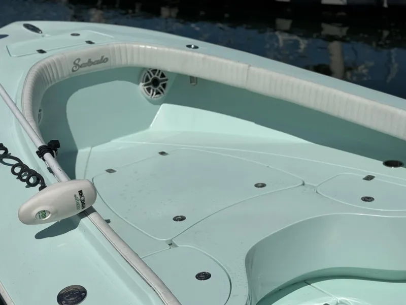 Slide: The Image of 2020 Sabalo 27 boat interior with light blue deck and white seating. - 8
