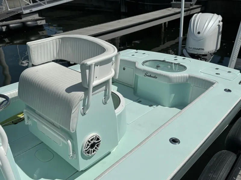 Slide: The Image of 2020 Sabalo 27 boat interior with seating and motor, docked at marina. - 9