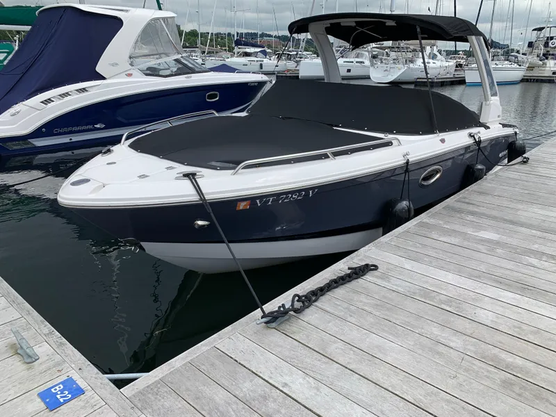 Slide: The Image of 2021 Chaparral 267 SSX boat docked at marina, covered and secured. - 22