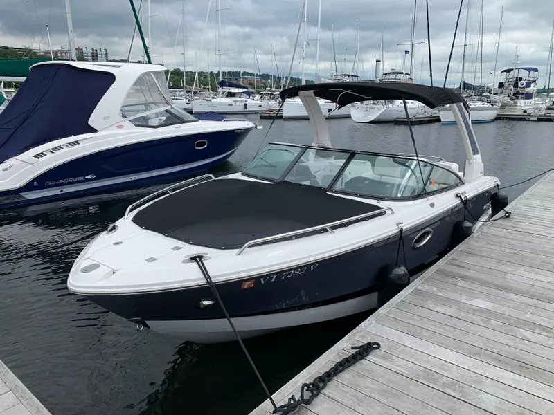 Slide: The Image of 2021 Chaparral 267 SSX boat docked at marina with overcast sky. - 24