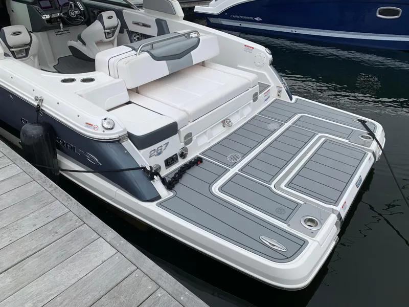 Slide: The Image of 2021 Chaparral 267 SSX boat with spacious swim platform docked at marina. - 27