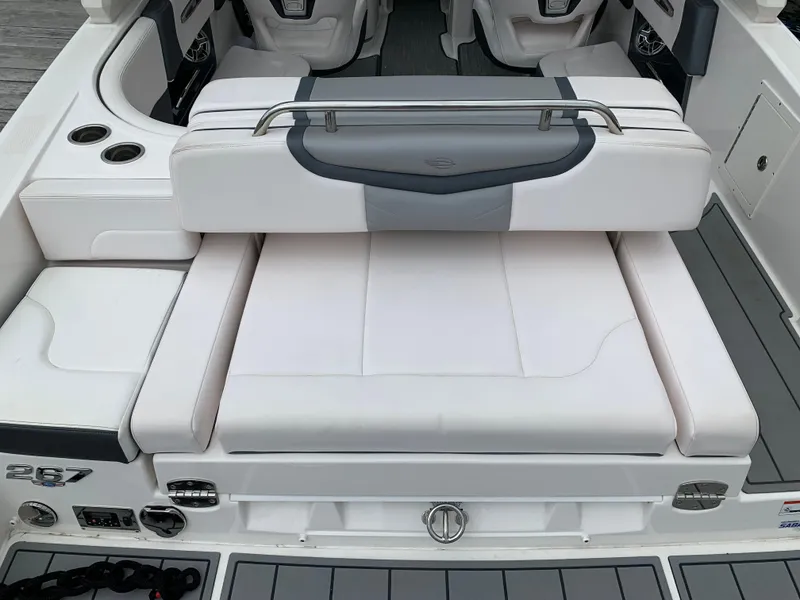 Slide: The Image of 2021 Chaparral 267 SSX boat interior with white seating and cup holders. - 29