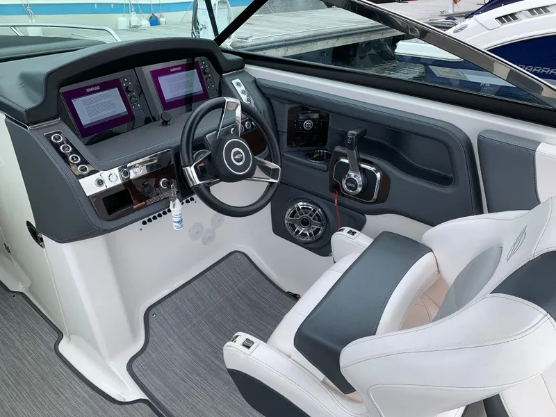 Slide: The Image of 2021 Chaparral 267 SSX boat cockpit with modern steering and dual displays. - 33