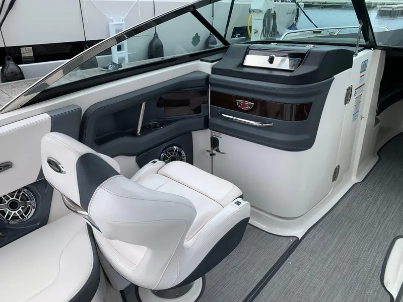 Slide: The Image of 2021 Chaparral 267 SSX boat interior with sleek seating and modern dashboard design. - 34