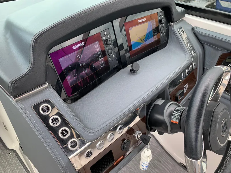 Slide: The Image of 2021 Chaparral 267 SSX dashboard with dual Simrad displays and steering wheel. - 36