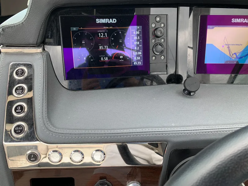 Slide: The Image of Dashboard of 2021 Chaparral 267 SSX boat with Simrad navigation displays. - 38