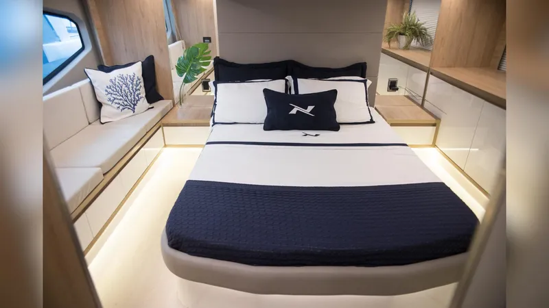 Slide: The Image of Luxurious bedroom interior of 2025 NX Boats NX50 Invictus HT with elegant bedding and decor. - 14