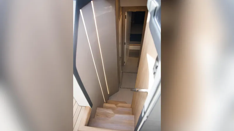 Slide: The Image of Staircase interior of 2025 NX Boats NX50 Invictus HT yacht, featuring modern design. - 16