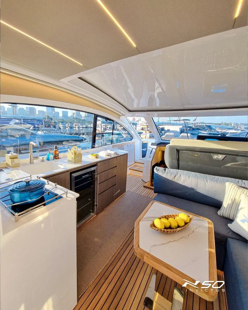 Slide: The Image of Luxurious interior of 2025 NX Boats NX 50 INVICTUS HT yacht with modern kitchen and seating area. - 32