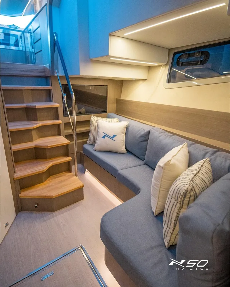 Slide: The Image of Luxurious interior of 2025 NX Boats NX 50 INVICTUS HT with modern seating and staircase. - 33
