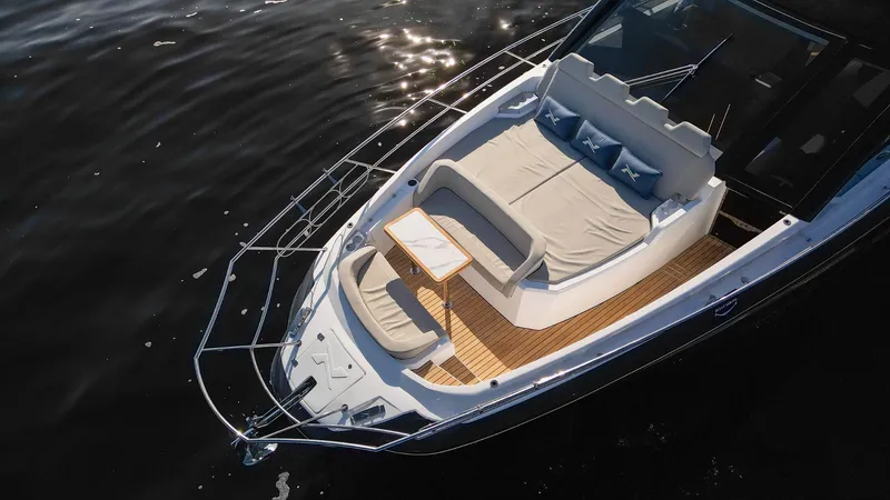 Slide: The Image of 2025 NX Boats NX50 Invictus HT luxury yacht with sun deck on calm water. - 6