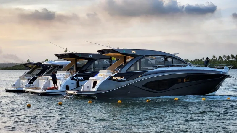 Slide: The Image of 2025 NX Boats NX50 Invictus HT yachts docked on serene water at sunset. - 8