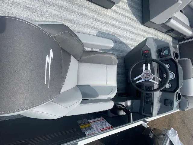 Slide: The Image of 2025 Bennington S21 Cruise boat interior with steering wheel and captain's chair. - 4