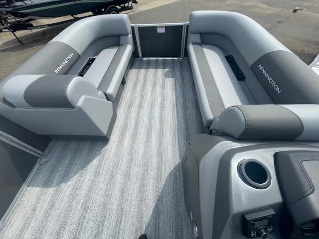 Slide: The Image of 2025 Bennington S21 Cruise pontoon boat interior with gray seating and flooring. - 6