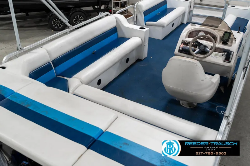 Slide: The Image of Interior of 2005 SunChaser 820 pontoon boat with blue and white seating. - 13