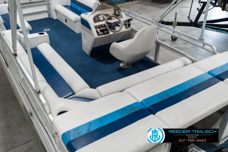 Slide: The Image of 2005 SunChaser 820 pontoon boat interior with blue and white seating and steering console. - 14