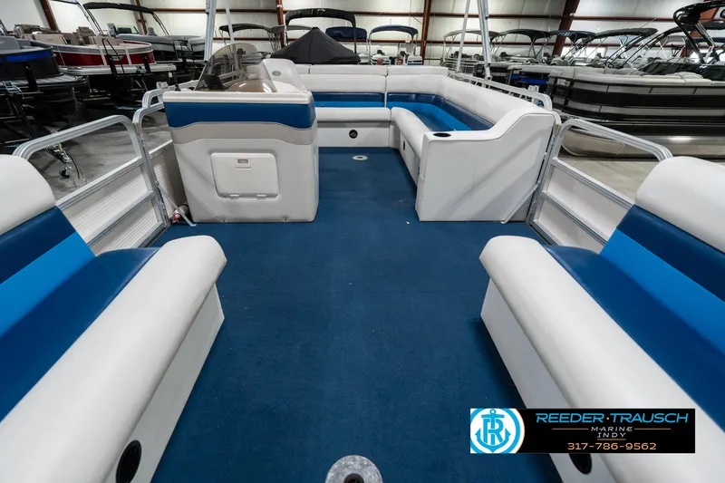 Slide: The Image of Interior of a 2005 SunChaser 820 pontoon boat with blue and white seating. - 15