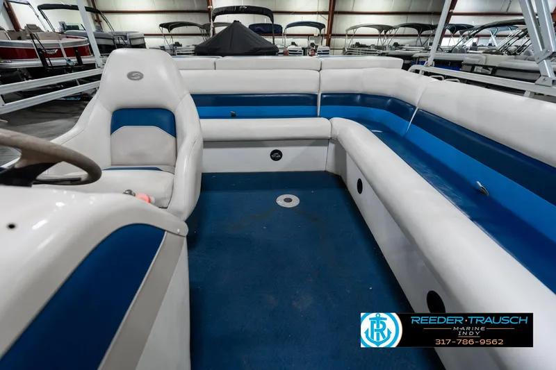 Slide: The Image of Interior of a 2005 SunChaser 820 boat with blue and white seating. - 16