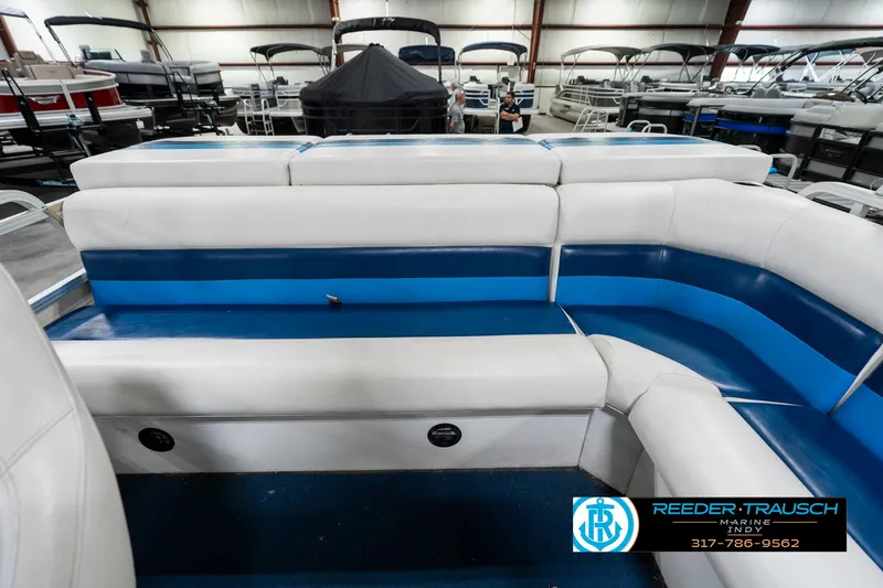 Slide: The Image of 2005 SunChaser 820 pontoon boat interior with blue and white seating at Reeder-Trausch Marine. - 17