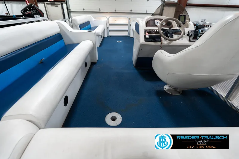 Slide: The Image of Interior of a 2005 SunChaser 820 boat with blue and white seating. - 18