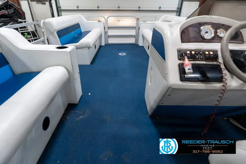 Slide: The Image of Interior of a 2005 SunChaser 820 pontoon boat with blue and white seating. - 19