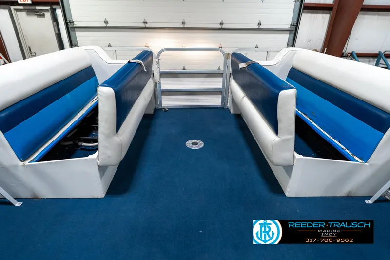 Slide: The Image of Interior of a 2005 SunChaser 820 boat with blue and white seating. - 21