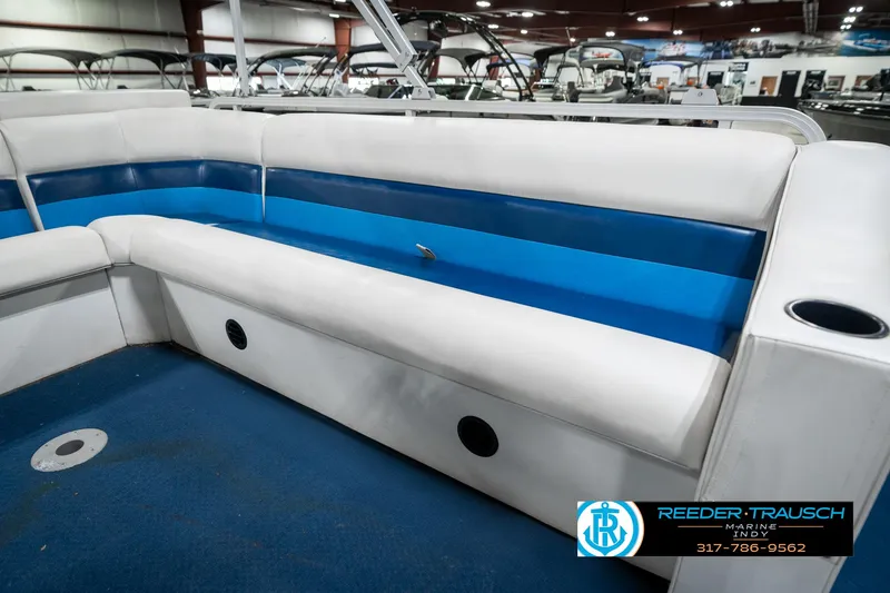Slide: The Image of 2005 SunChaser 820 boat interior with blue and white seating in a showroom. - 22