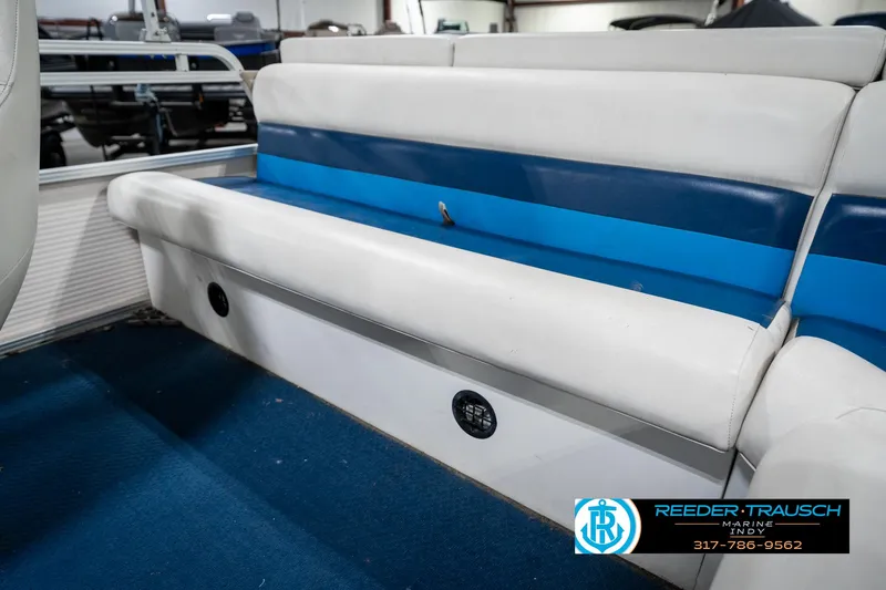 Slide: The Image of 2005 SunChaser 820 boat interior with blue and white seating. - 24