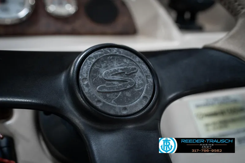 Slide: The Image of Close-up of a 2005 SunChaser 820 steering wheel with logo and Reeder-Trausch Marine contact. - 28