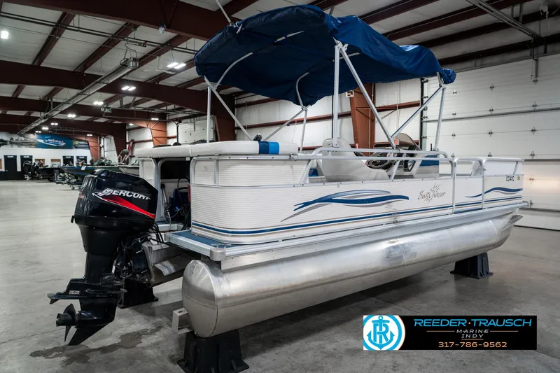 Slide: The Image of 2005 SunChaser 820 pontoon boat with blue canopy in indoor showroom. - 7