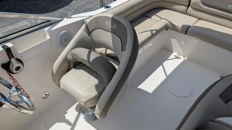 Slide: The Image of 2021 Key West 203 DFS boat interior with cushioned seating and steering wheel. - 11