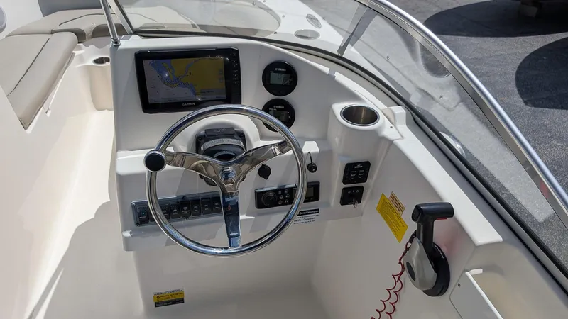 Slide: The Image of 2021 Key West 203 DFS boat dashboard with steering wheel and navigation display. - 13