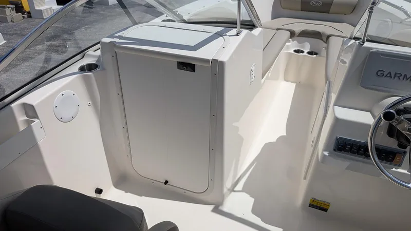 Slide: The Image of 2021 Key West 203 DFS boat interior with steering wheel and seating area. - 15