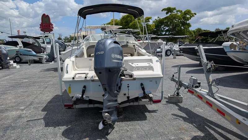 Slide: The Image of 2021 Key West 203 DFS boat with Yamaha 150 engine in a dealership lot. - 2