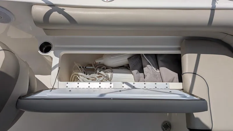 Slide: The Image of Open storage compartment on a 2021 Key West 203 DFS boat, containing rope and accessories. - 9