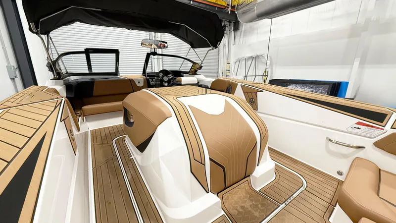 Slide: The Image of 2025 Nautique Ski boat interior with tan and white upholstery, showcasing sleek design and modern features. - 6