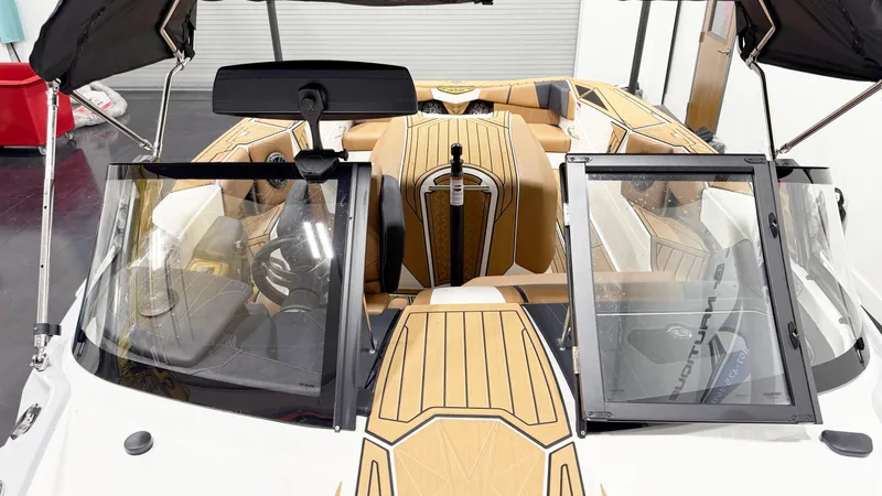 Slide: The Image of 2025 Nautique Ski boat interior with tan upholstery and sleek design. - 7