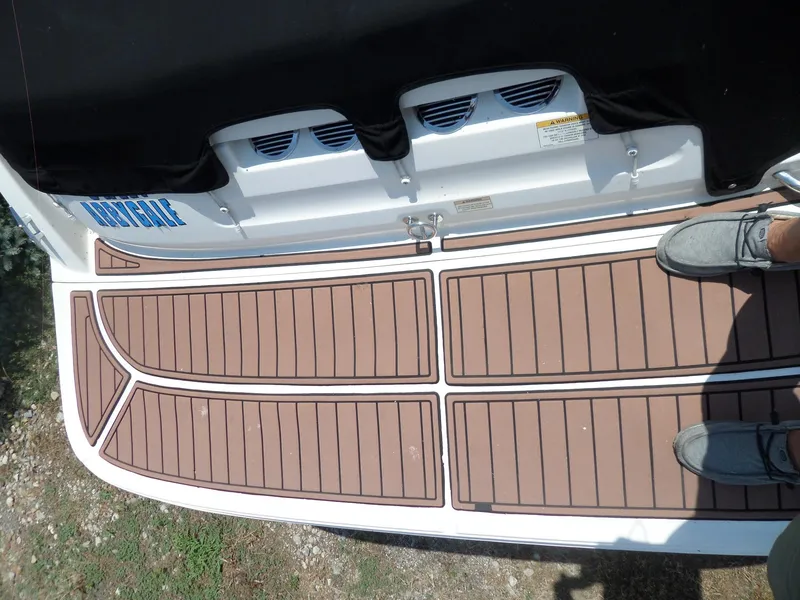 Slide: The Image of 2017 Bayliner VR6 Bowrider I/O swim platform with brown decking and person standing. - 10