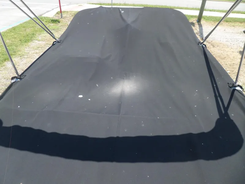 Slide: The Image of 2017 Bayliner VR6 Bowrider I/O with black boat cover, parked outdoors. - 12